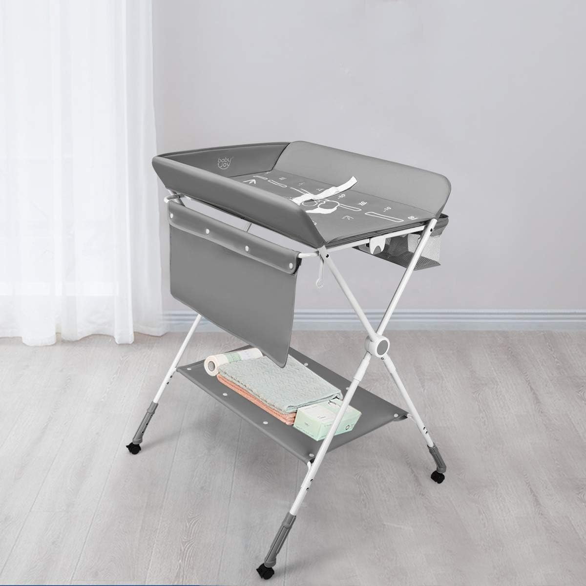 A foldable baby changing and dressing table, featuring storage baskets and side pockets, a spacious bottom shelf, and wheels for easy mobility—the ideal, practical solution for every mother to make baby care easier and more comfortable!