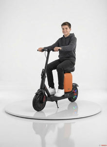 An innovative electric scooter for kids featuring a practical design, a comfortable seat, and a stylish orange storage box; it is equipped with light-up wheels for fun illumination and a modern look—from Happy Kiddo.