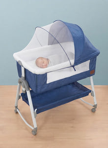 Kidilo Multifunctional 4-in-1 Foldable Bedside Crib: A portable newborn bassinet and infant travel bed featuring a large storage basket, soft bedding, 3-level adjustable height, and a mosquito net(Blue).