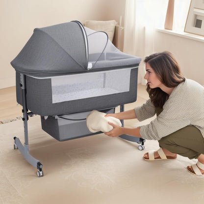 Kidilo Multifunctional 4-in-1 Foldable Bedside Crib: A portable newborn bassinet and infant travel bed featuring a large storage basket, soft bedding, 3-level adjustable height, and a mosquito net(Gray).