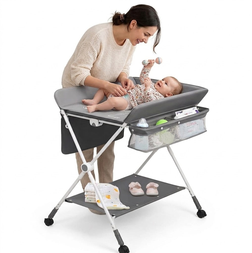 A foldable baby changing and dressing table, featuring storage baskets and side pockets, a spacious bottom shelf, and wheels for easy mobility—the ideal, practical solution for every mother to make baby care easier and more comfortable!